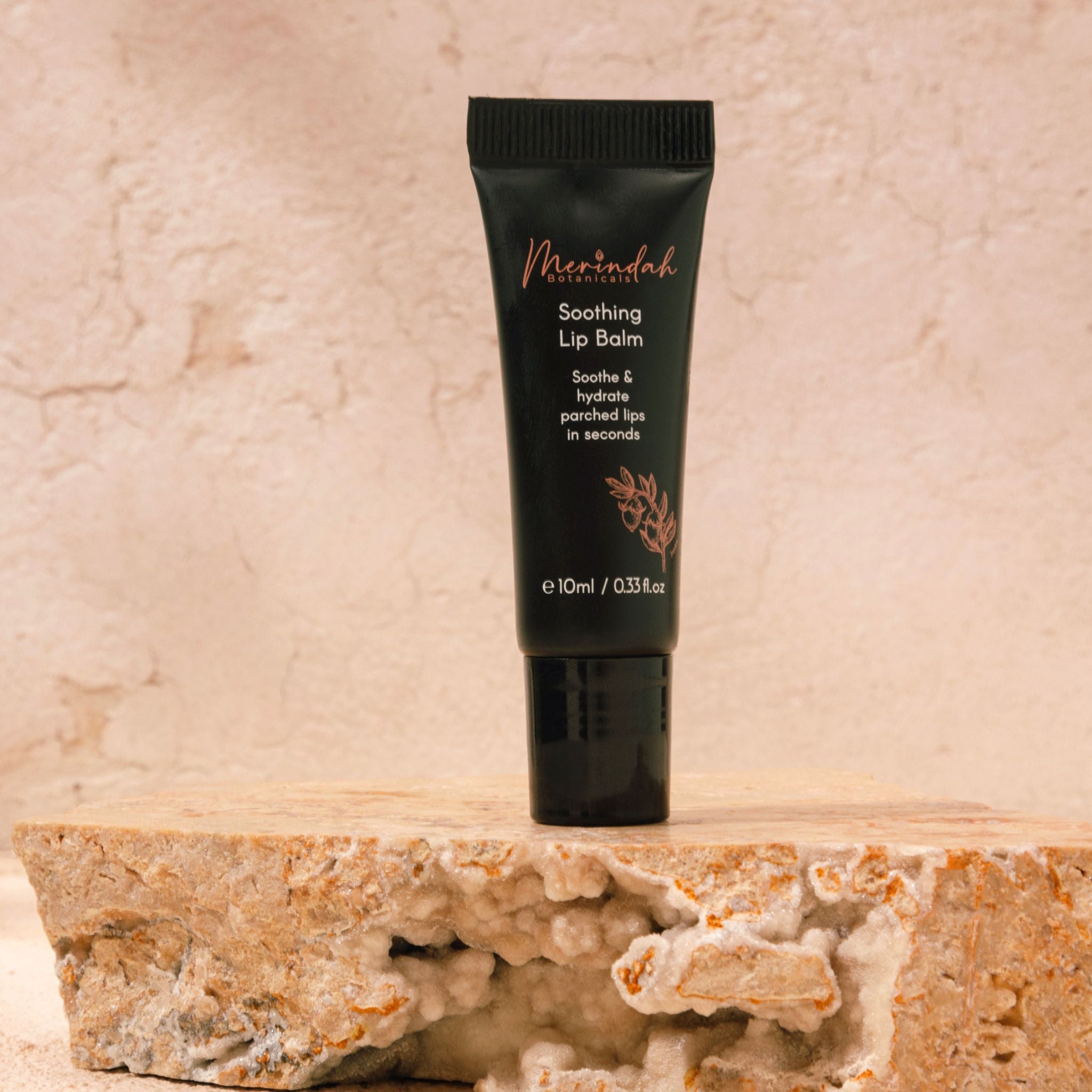 Soothing natural lip balm tube displayed on stone, a vegan lip balm that provides deep hydration and protection for dry lips.