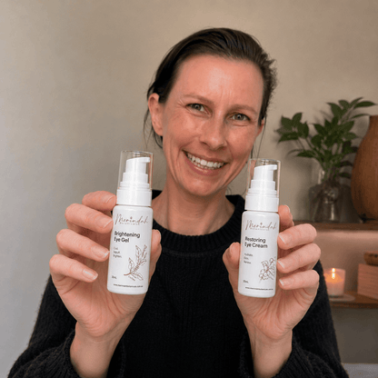 A smiling woman is holding a bottle of Merindah Botanicals&
